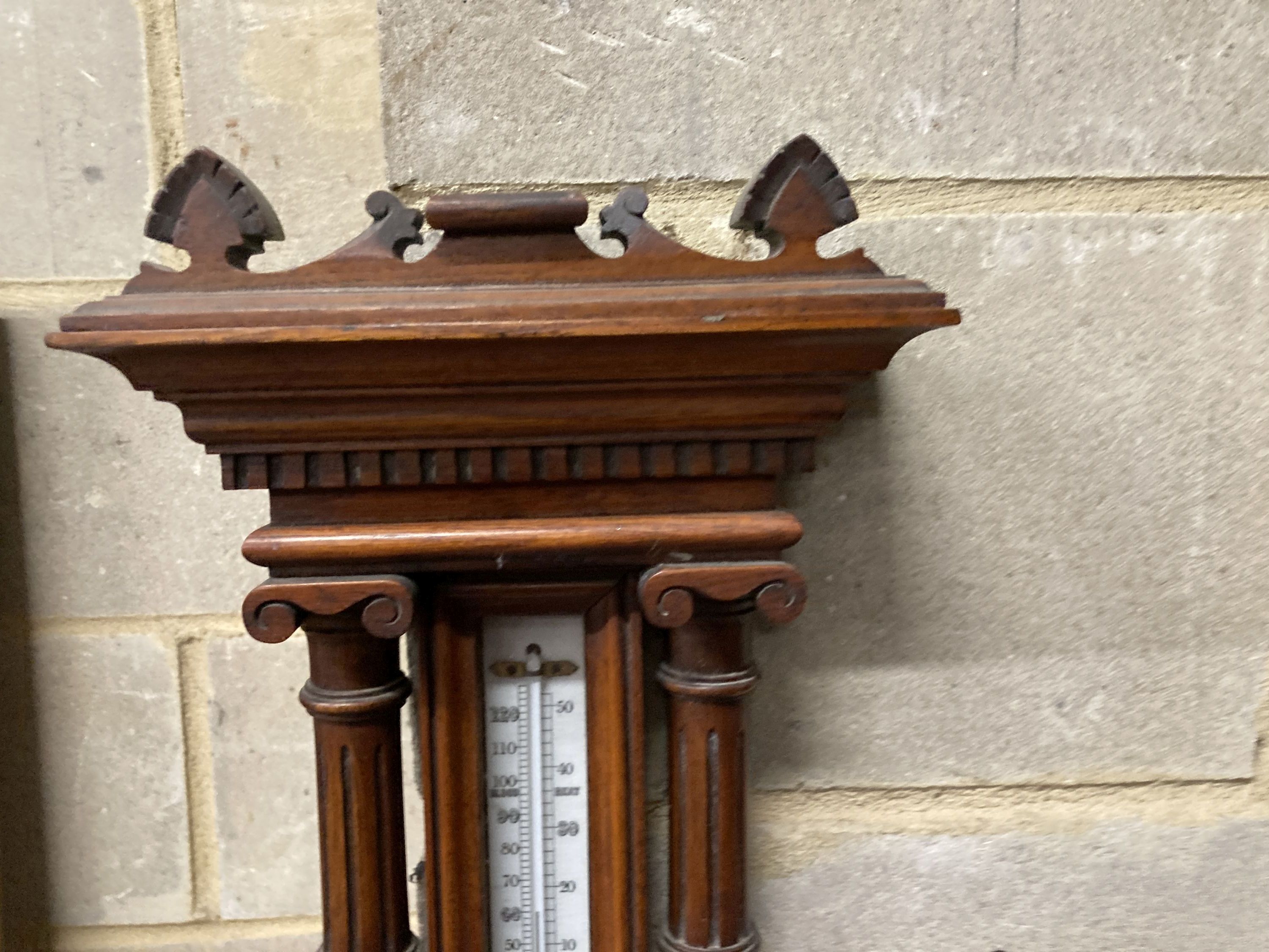 An Edwardian carved oak aneroid barometer and thermometer, height 80cm